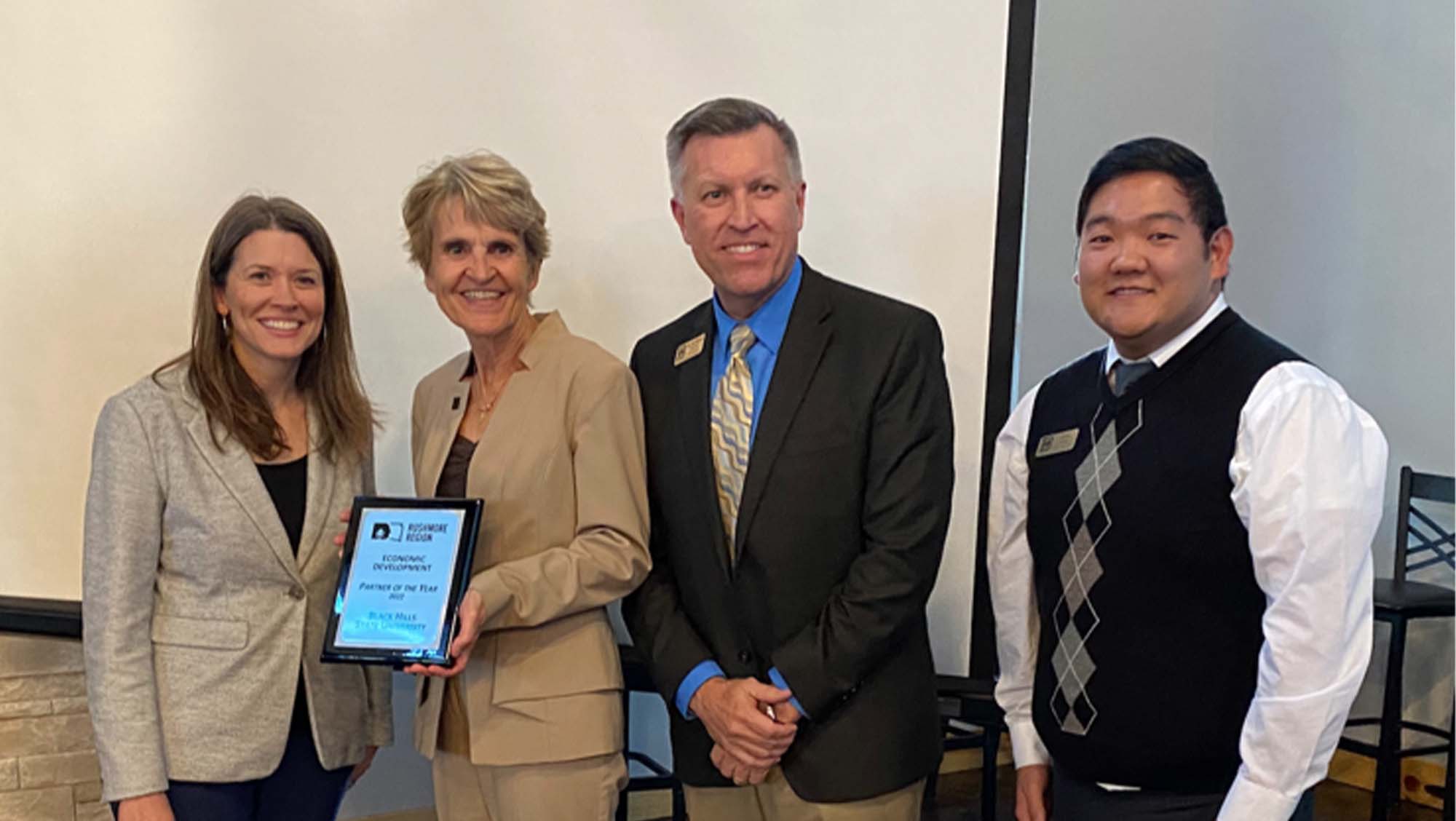 Fran White (left), executive director of BHCED, presents the Rushmore Region Partner of the Year award to BHSU President Laurie S. Nichols, r. Jon Kilpinen, provost and vice president for Academic Affairs, and Jin Kim, director of Career Development at the annual Small Business RoundUP event hosted by 新万博app_新万博体育-娱乐*官网@ Hills Community Economic Development. 