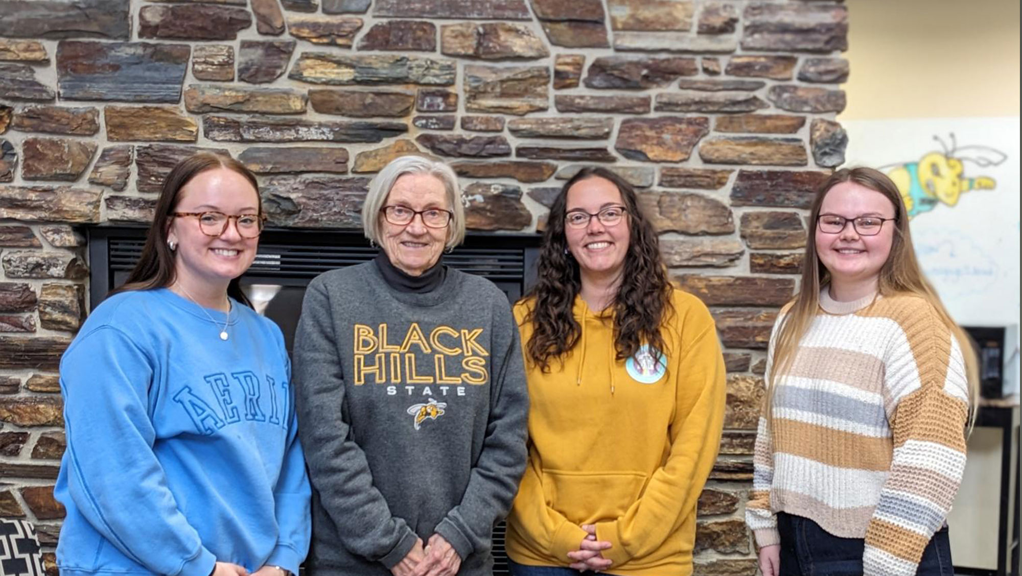 app_-*@ Hills State University students meet with the donor of their scholarships, Carol Lundberg. Lundberg recently increased her scholarship, adding three new recipients this spring. Standing (left to right) are Hadley Marquardt, Carol Lundberg, Marissa Tuttle, and Katie Pedneau.