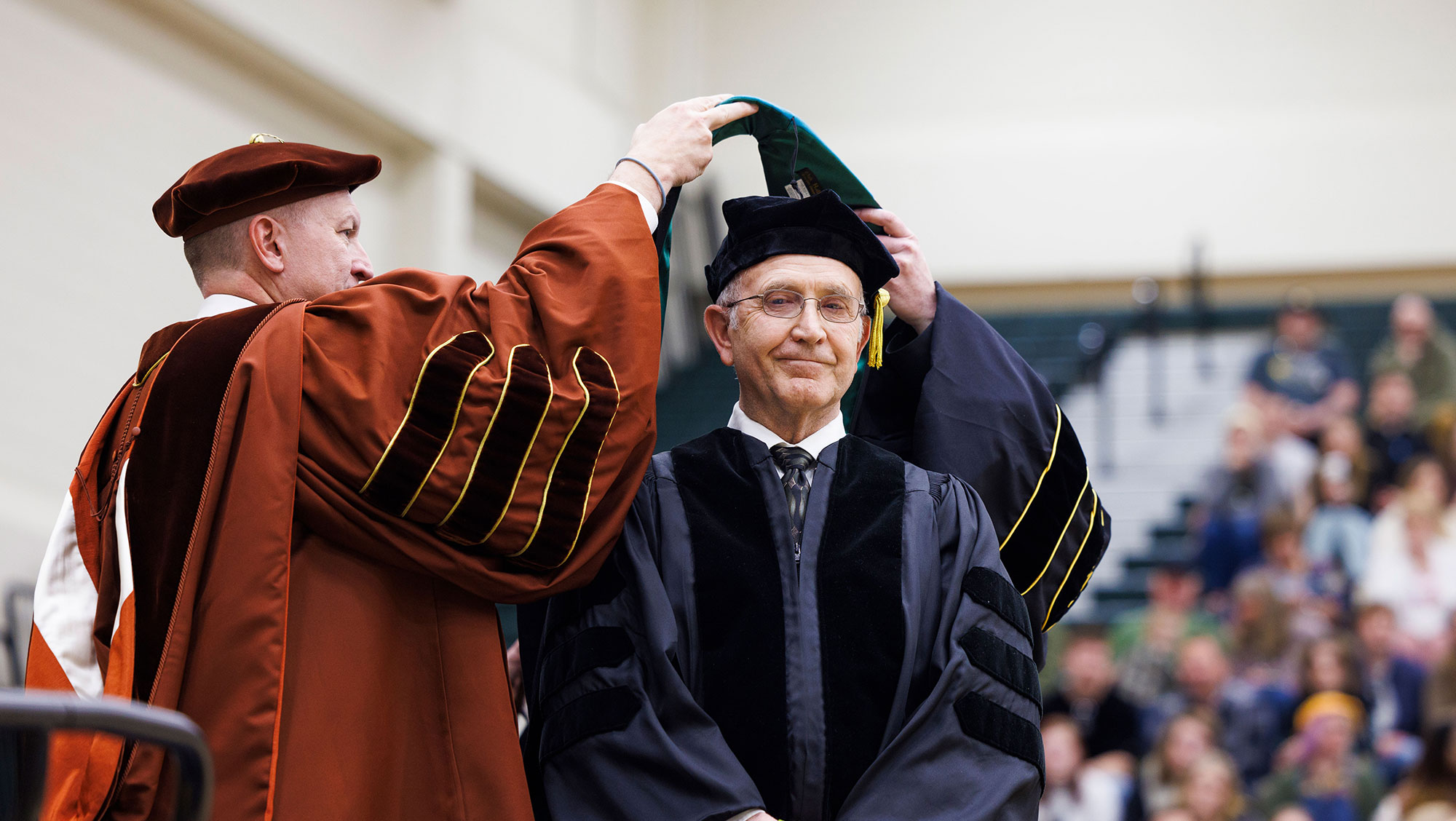 Jim D. Neiman receives his doctorate graduation hood after being presented with an honorary doctorate from app_-*@ Hills State University at the 187th Commencement Ceremony May 4.